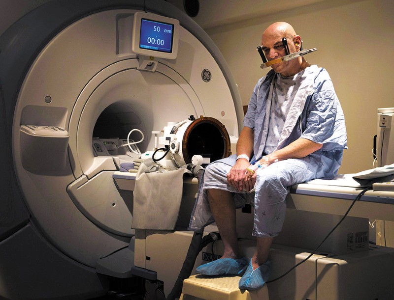 A patient sits waiting for ultrasound treatment